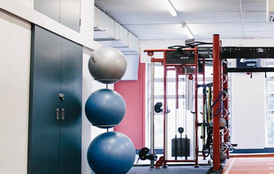 A gym with exercise balls and gym equipment